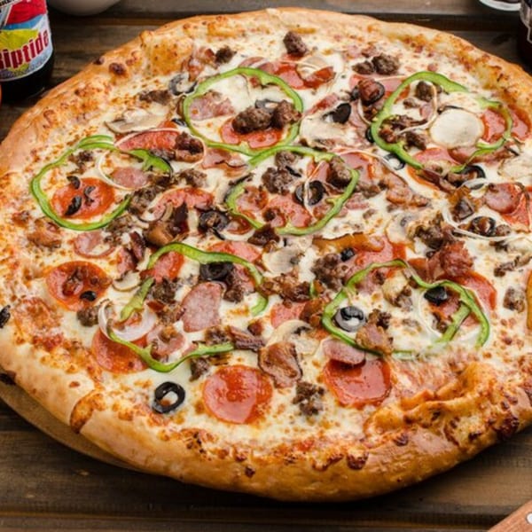 East Hill Pizza's fully loaded pizza with pepperoni, sausage, green peppers, onions, mushrooms, and olives.